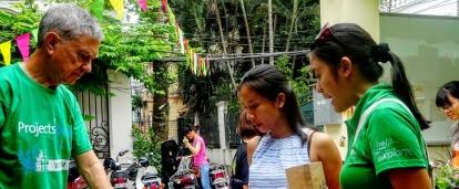 Projects Abroad International Development Interns selling products at a market in Hanoi during their International Development internship in Vietnam. Male and Female International Development Interns sell clothing products at a market during their work placements in Vietnam.